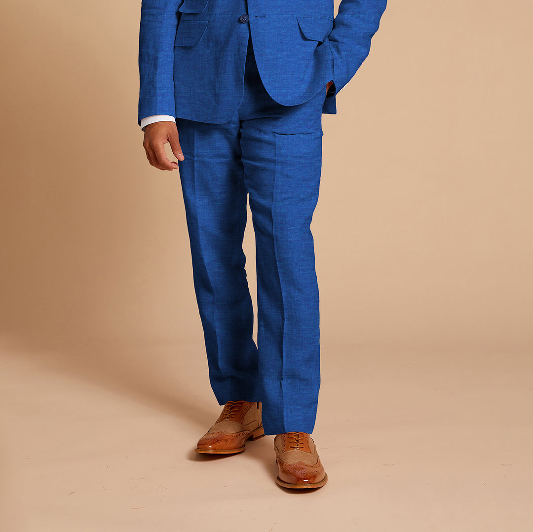 A man models the Inserch Linen 2pc Set (Shirt and Pants) in River Blue by Inserch against a plain beige background.