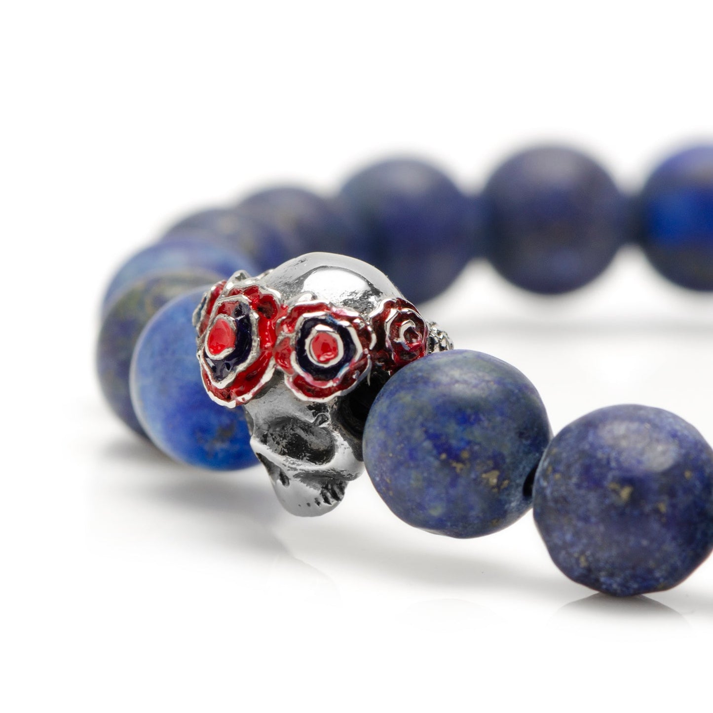 The Gothic Skull Pop Rubber Bracelet Navy 39cm by Cufflinks.com features dark blue beads and a silver skull bead with red accents, finished with a unique clasp for standout style.