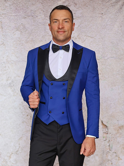 A man stands against a textured light background wearing an Insomnia MANZINI ROME Slim Fit 3-Piece Stretch Spandex Royal Tuxedo Suit.