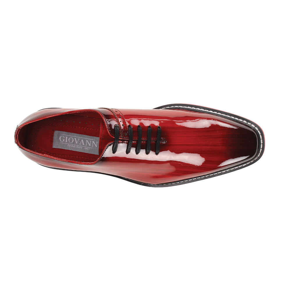 The Giovanni Ruben Red Patent Leather Shoes by GIOVANNI feature glossy red leather, black laces, a black and white ridged lightweight sole, and a pointed toe.
