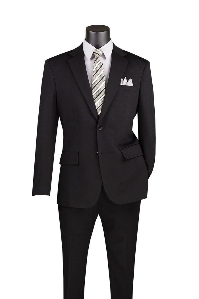 A mannequin showcases a Vinci Suits Slim Fit 2 Piece SDX-3 suit in black, featuring stretch fabric and an adjustable waistband, paired with a white shirt, striped tie, and pocket square.