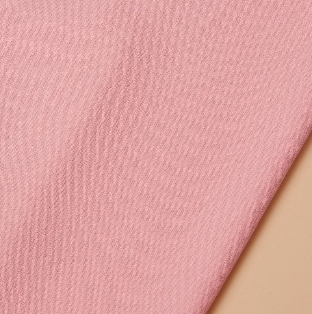 A close-up of Inserch Crepe Camp Collar Shirt fabric in Blue Mist, made with high-twist poly-crepe, ideal for a regular fit, displayed on a beige surface. Available as style SE9356 in Plum, Summer Pink, and Blue Mist.