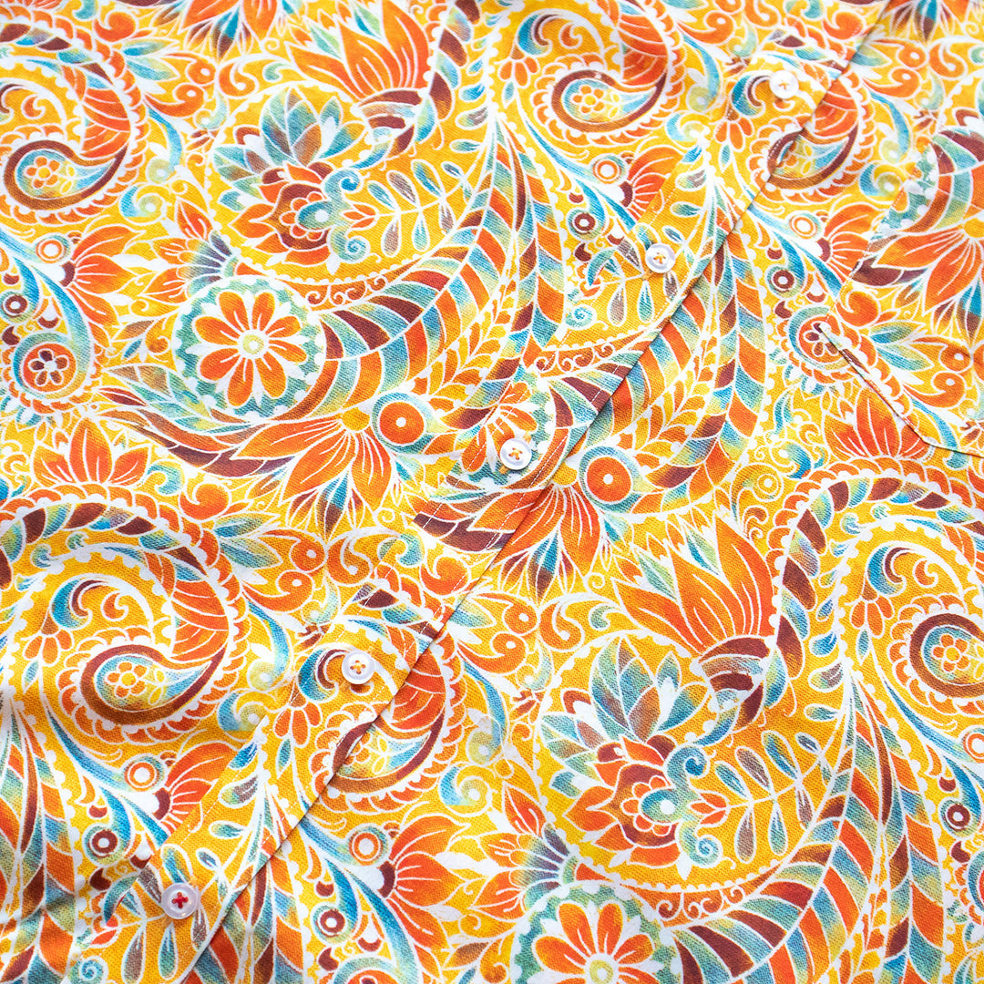 The Inserch SS Paisley Print Shirt SS011-00029 Orange is a short-sleeve premium cotton button-up, featuring a multicolored paisley and floral pattern in red, yellow, blue, and green, shown laid flat on a light background.