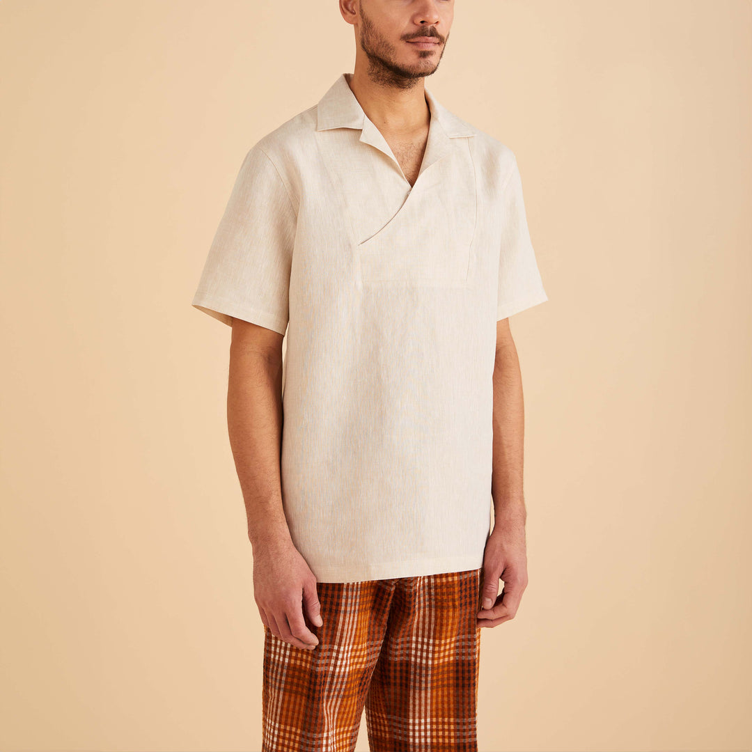 A man wearing an Inserch Linen Pull Over Shirt SS813-00006 Oatmeal and orange plaid pants stands against a plain background.