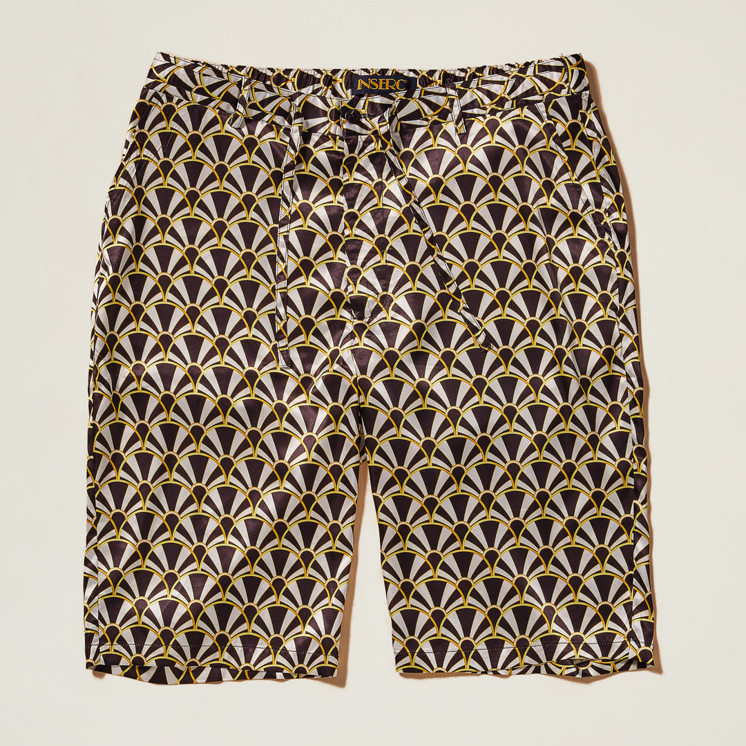 The Inserch Art Nouveau Print Shorts ST051-00001 Black feature a geometric black, gold, and white pattern on shiny satin fabric, shown flat against a light background.