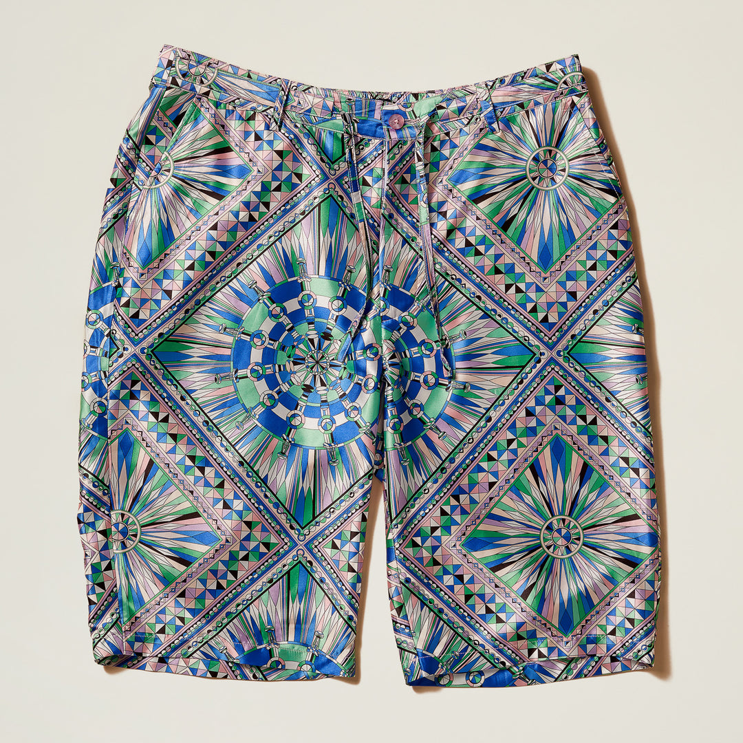 Inserch Kaleidoscope Print Shorts ST052-00126 Purple feature a geometric satin design in blue, green, pink, and purple tones with a regular fit and drawstring waist, shown laid flat on a light background.