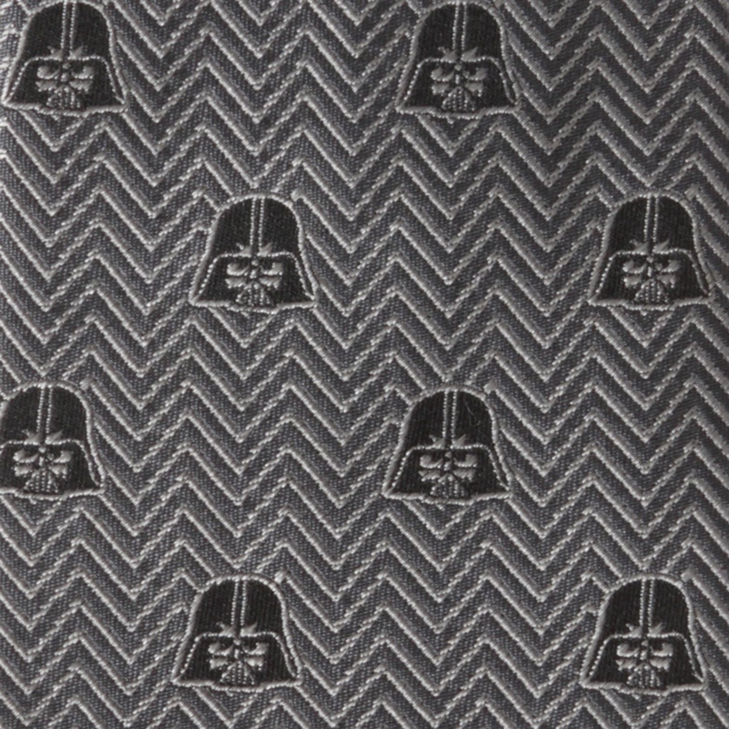 The Cufflinks.com Star Wars Darth Vader Black and Gray Herringbone Tie features a herringbone pattern with repeating Darth Vader helmet motifs.