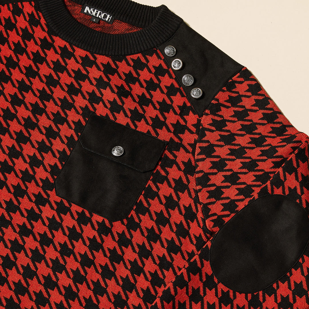 A man wears the Inserch Cotton Blend Houndstooth Crew Neck Sweater SW002-30 Red, featuring a red and black houndstooth pattern, shank buttons on the shoulders, a black chest pocket, and black trim.