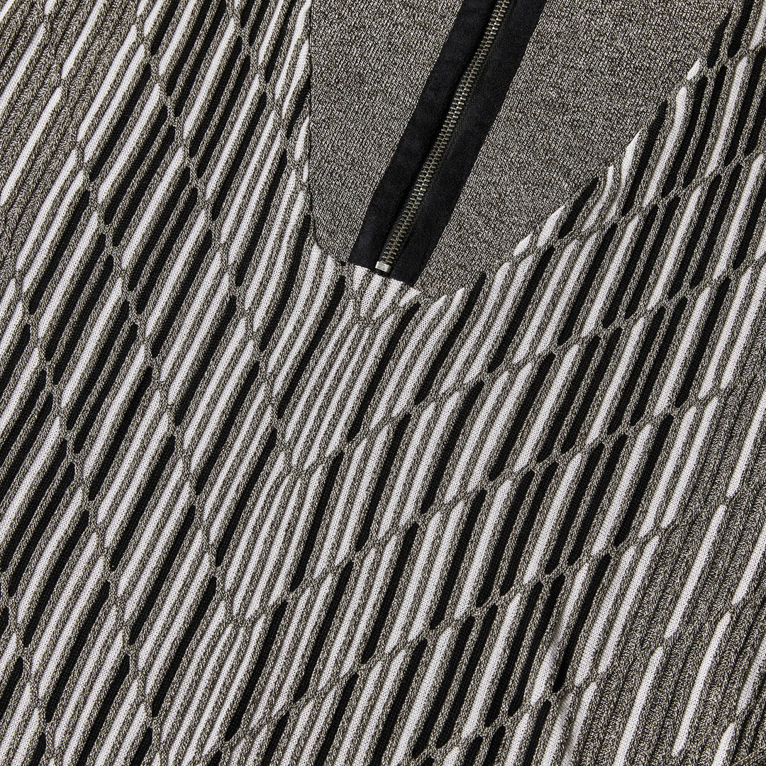 A man models the Inserch Geo Intarsia Half-Zip Sweater SW608-33 Grey, featuring a black and white geometric pattern, against a plain beige background.