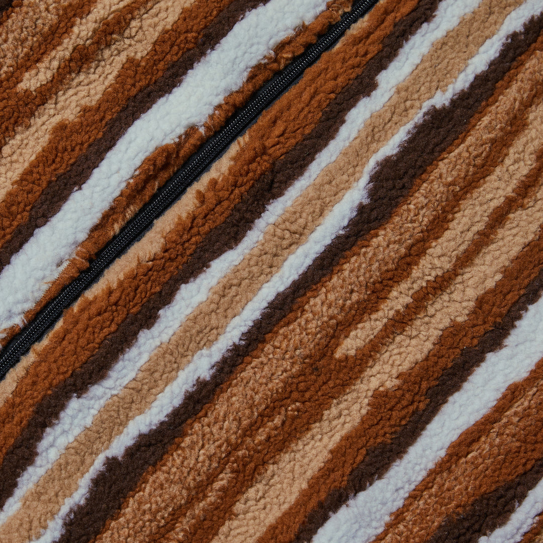 A man wears the Inserch Stripe Baseball Sweater Jacket SW610-121 Earth by Inserch over a white shirt with brown corduroy pants, standing against a plain beige background.