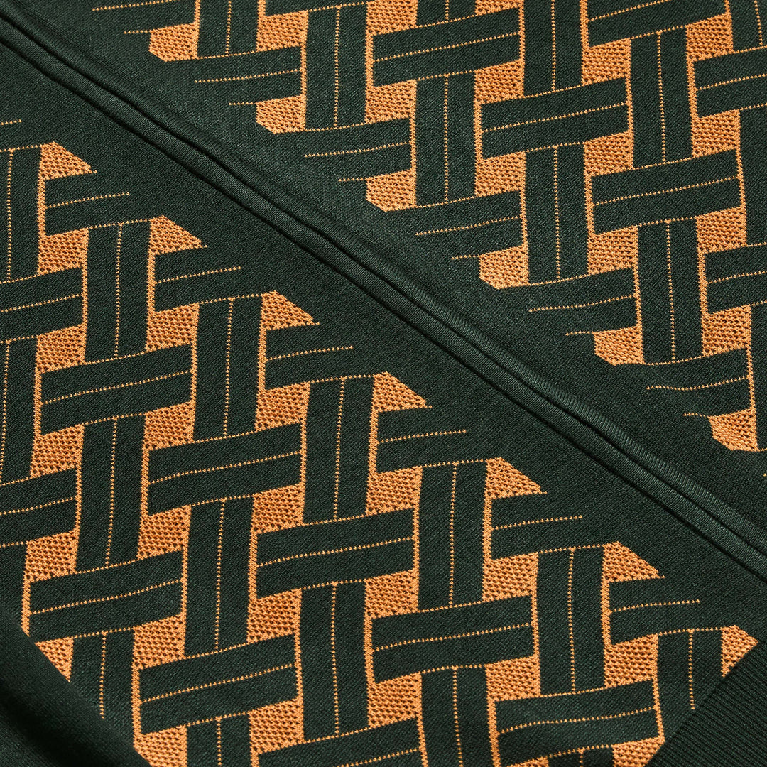 A man wears the Inserch Geometric Full Zip Sweater SW908-00021 in hunter green, featuring a woven geometric pattern on the front, paired with dark corduroy pants and a mustard-colored shirt.