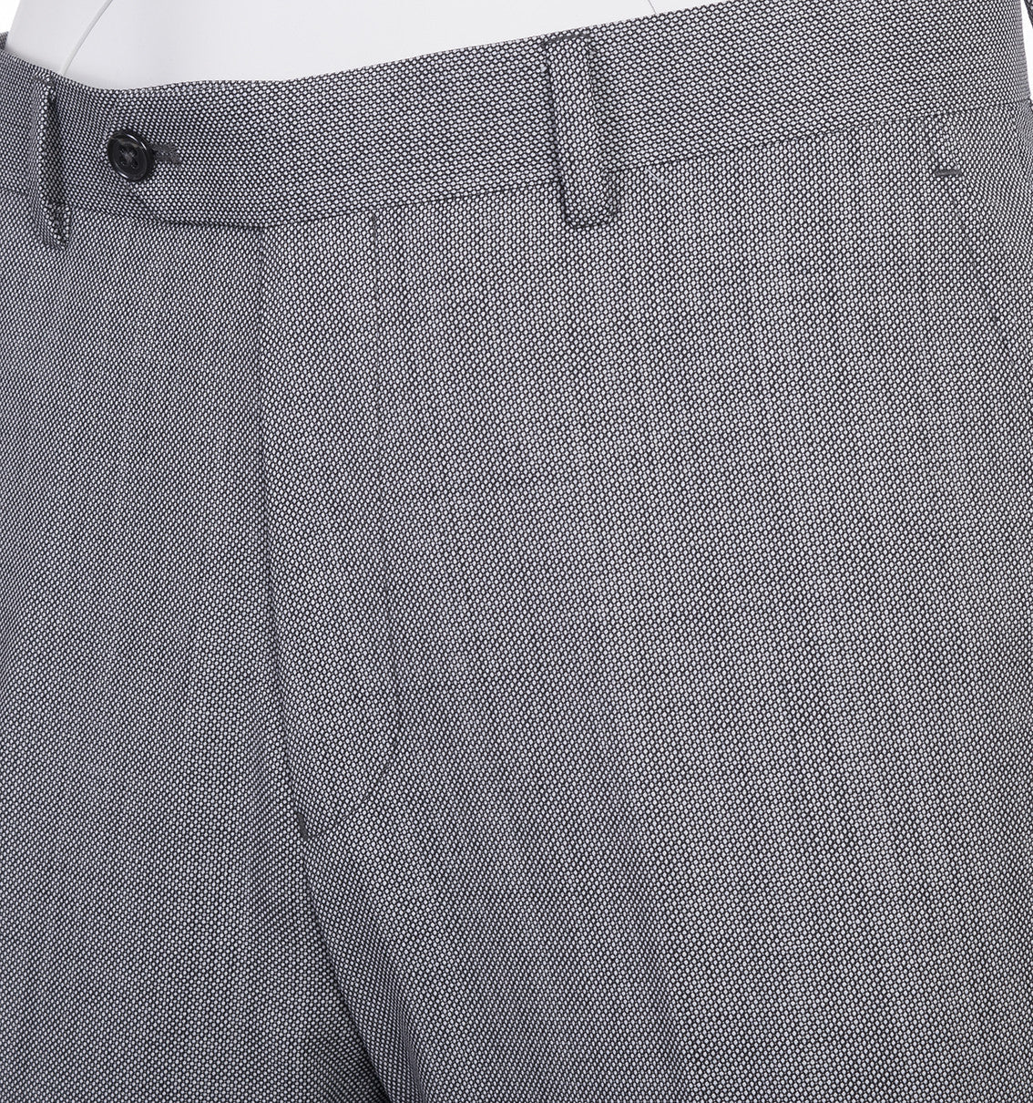 The Tiglio Luxe Novello Light Gray Birdseye Pure Wool Men’s Suit TIG1018 by Tiglio Luxe is showcased on a mannequin, featuring classic notch lapels, a crisp white dress shirt, and complemented by a purple plaid tie with a matching pocket square—an elegant ensemble that exemplifies the sophistication of Italian-inspired men’s tailoring.