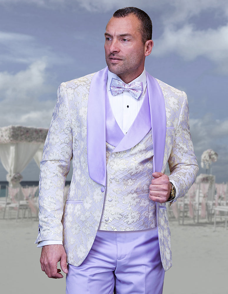 A man stands outdoors in front of a decorated wedding arch, wearing the STATEMENT CLOTHING | TIZANO-PURPLE modern fit suit by Statement Clothing, featuring a light purple and cream floral pattern with matching bow tie.