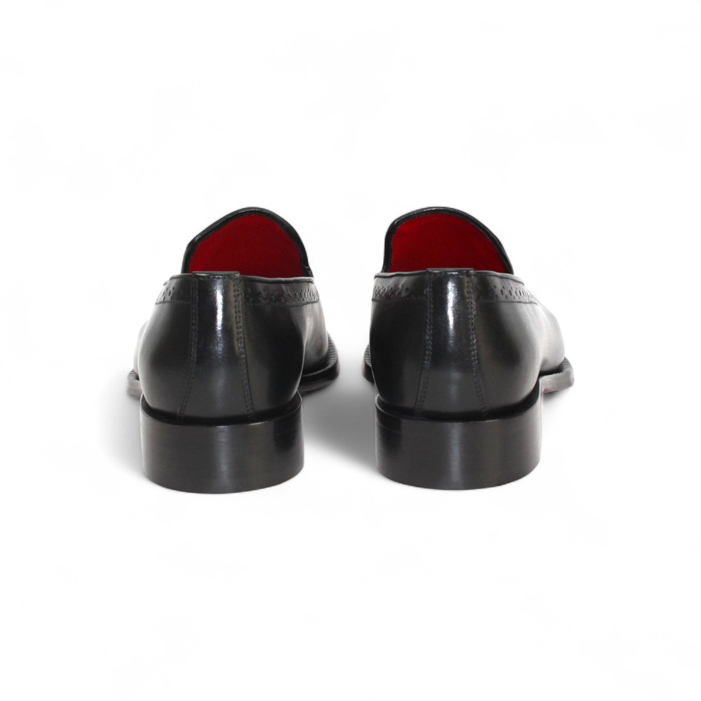 The Emilio Franco A014 Black loafer by Emilio Franco features handcrafted genuine black leather, subtle perforated detailing, a low heel, and red interior lining, showcased on a white background.