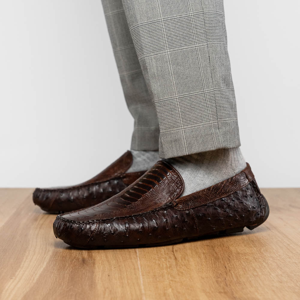 The Alba Kango Tabac by Marco Di Milano: brown textured leather loafers with visible stitching, one flat and one side-propped to reveal the sole—luxury footwear with artisanal hand-painted finishes.