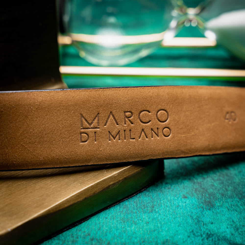 The Emilio Belt Cognac by Marco Di Milano features textured cognac leather and a silver buckle engraved with the brand name, shown on a white background—a refined accessory that complements Marco Di Milano’s luxury footwear.