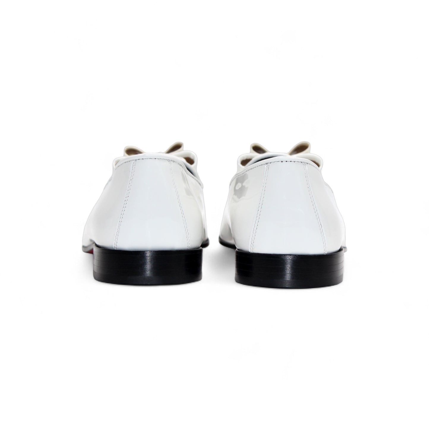 The Duca Amalfi White loafer by Duca Di Matiste is a luxury white leather shoe with a low black heel and bow detail, displayed in side view against a white background.