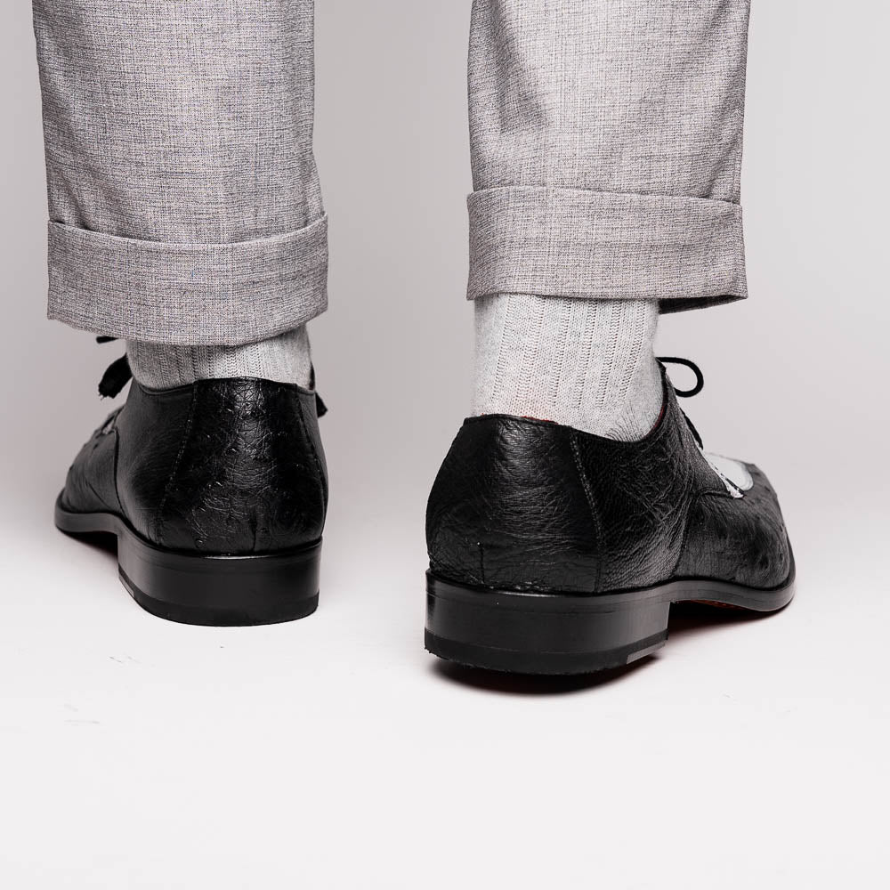 The Andretti White / Black by Marco Di Milano is a black and white leather dress shoe with a textured pattern, black laces, and a brown embossed leather sole—luxury footwear for any occasion.