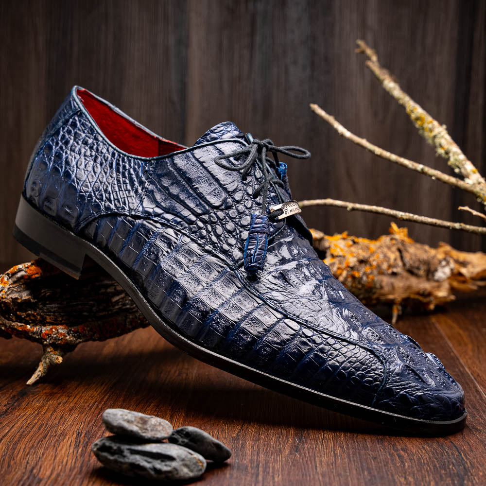 A pair of Marco Di Milano Apricena Midnight Blue caiman crocodile derby shoes, one upright and the other on its side showing the sole, with black laces for a luxury dress look.