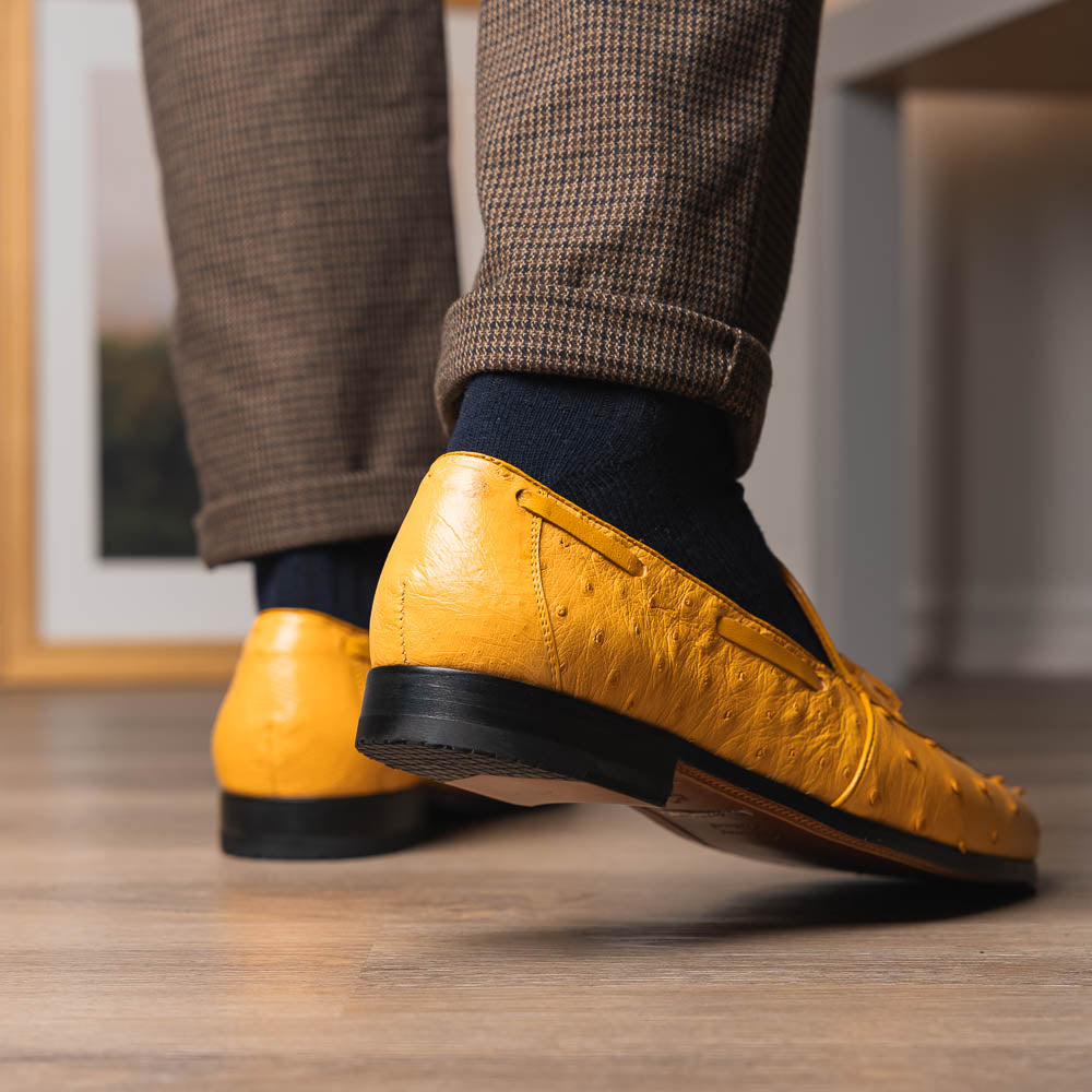 The Aubiere Buttercup by Marco Di Milano are yellow ostrich tassel loafers with red interior lining and branded leather soles, expertly crafted from genuine ostrich, presented against a white background.