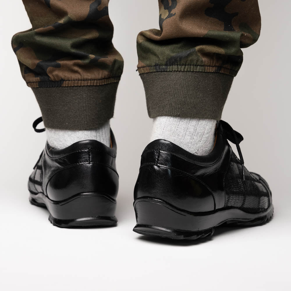 The Bari Black by Marco Di Milano: black leather lace-up dress shoes with textured detailing and a hand-painted finish; one shoe rests against the other to reveal its sole—a true statement in luxury footwear.