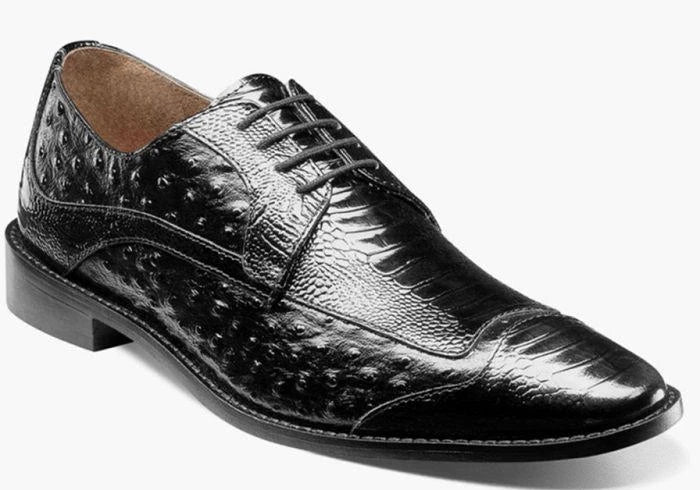 A single Stacy Adams Fanelli Wing Tip Oxford - 25536 in black, featuring a textured, patterned leather surface, lace-up closure, low heel, and brown inner lining is displayed on a white background. Please note: this STACY ADAMS item is final sale and not eligible for return or exchange.