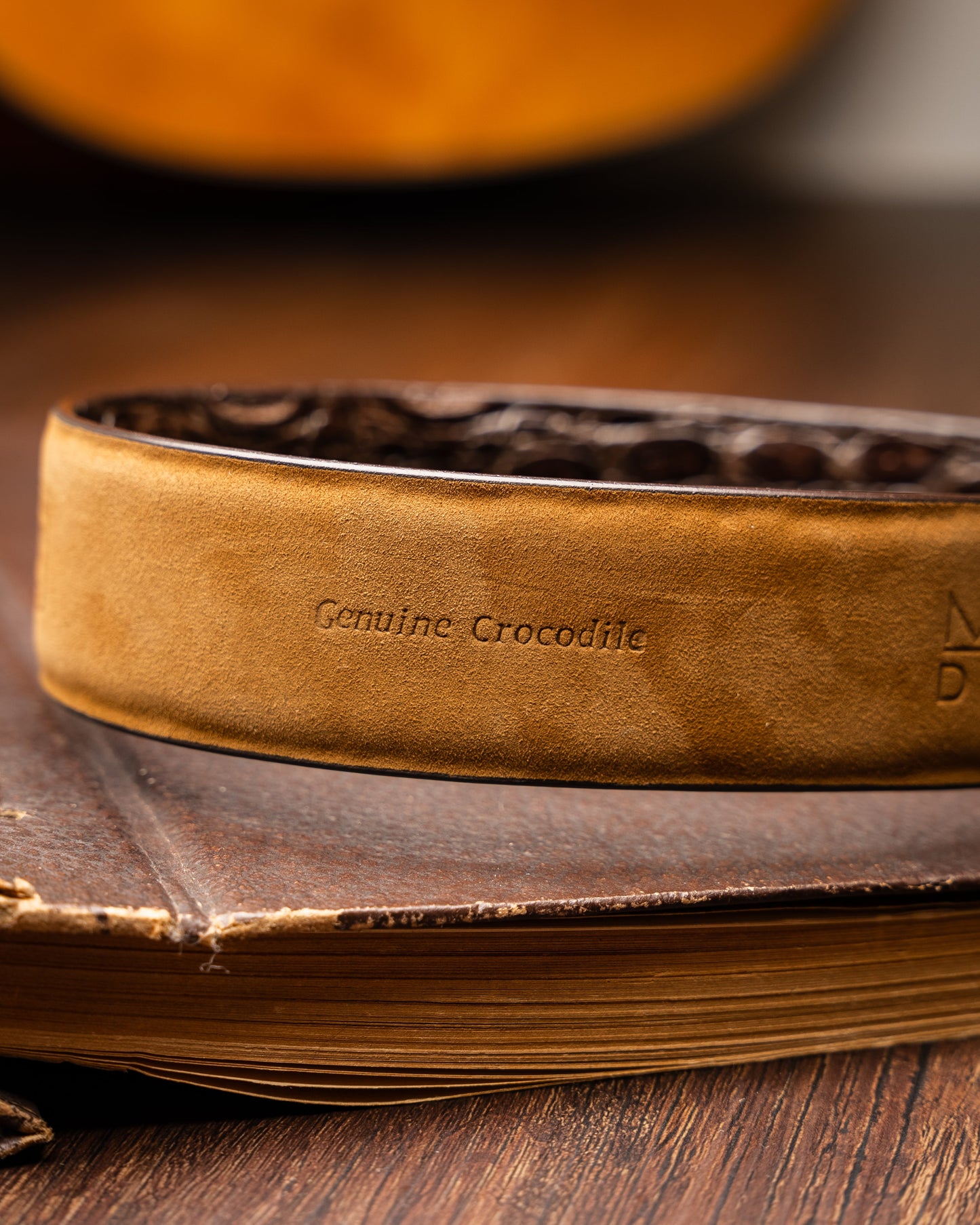 The Massimo Belt Brown by Marco Di Milano features an exotic caiman flank design and a silver engraved buckle—an elegant accessory to pair with your luxury footwear collection.