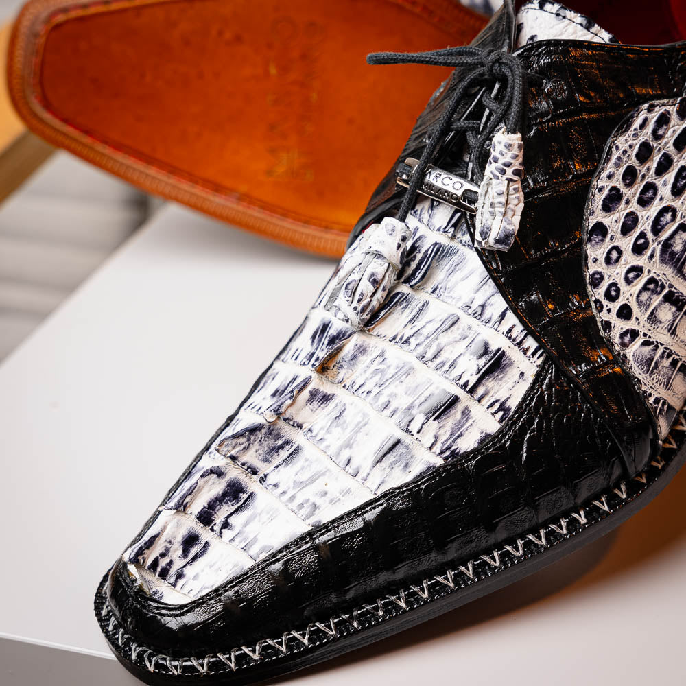A pair of Marco Di Milano Caribe Newspaper / Black luxury dress shoes crafted from genuine hornback caiman crocodile leather, with one upright and the other on its side showing the brown sole and exquisite hand-painted details.