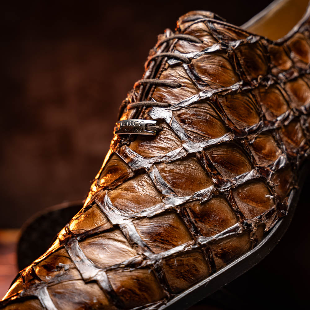 The Olivieri Clear Brown oxford shoes by Marco Di Milano showcase a textured crocodile leather design; one shoe stands upright as the other lies on its side, displaying the sole.