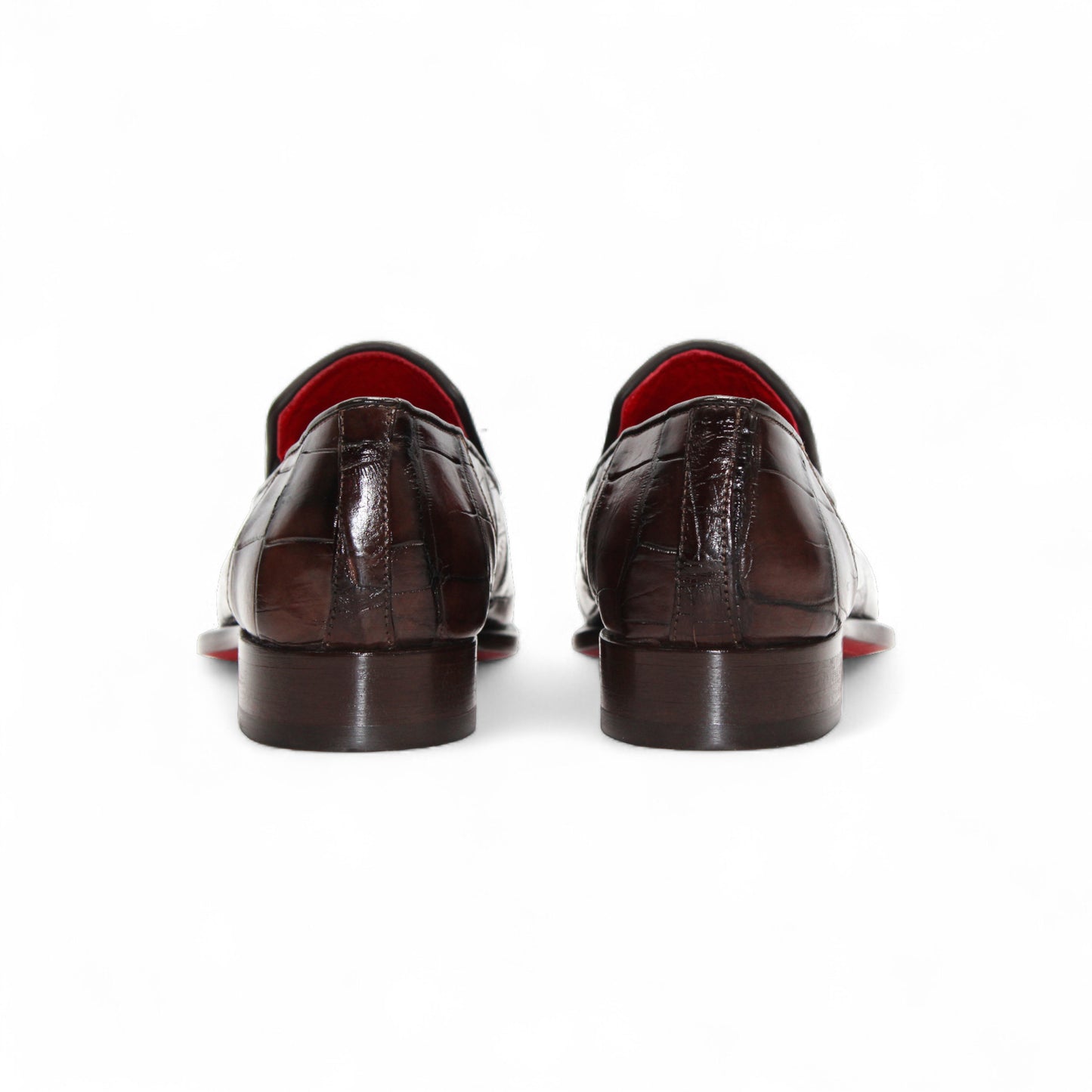 The Fennix Dustin Brown loafer by Fennix of Italy features premium brown leather, Italian craftsmanship, a textured pattern, low heel, and red interior lining, showcased in a side profile against a white background.