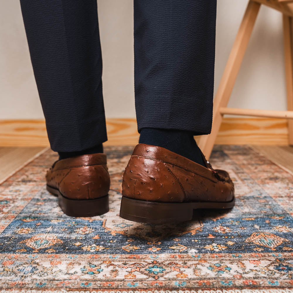 Experience luxury with the Ferrioni Kango Tabac by Marco Di Milano—brown leather men's loafers featuring a textured finish, metal buckle detail, and signature branding on the sole.