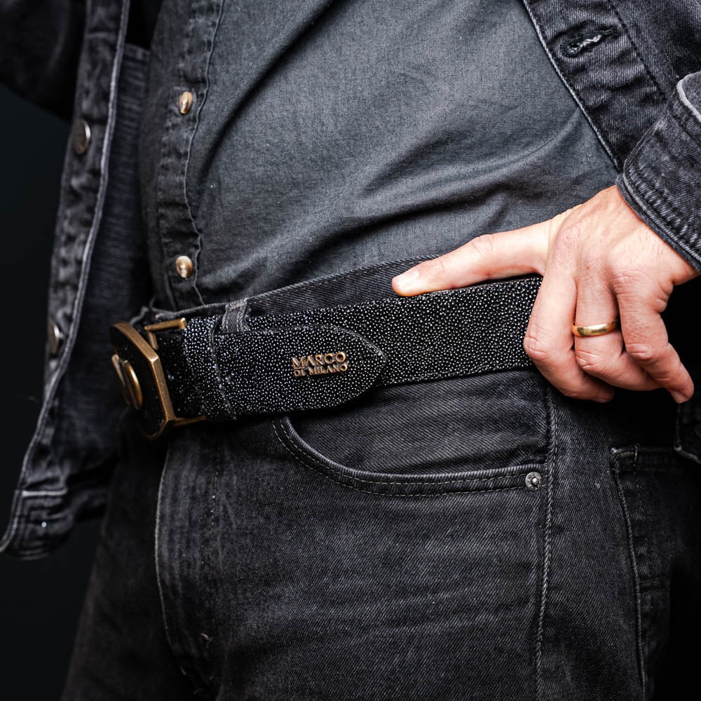 The Georgia Belt Black by Marco Di Milano is a luxury men's belt made from genuine stingray skin, featuring a bold black texture and a large gold "MD" buckle.