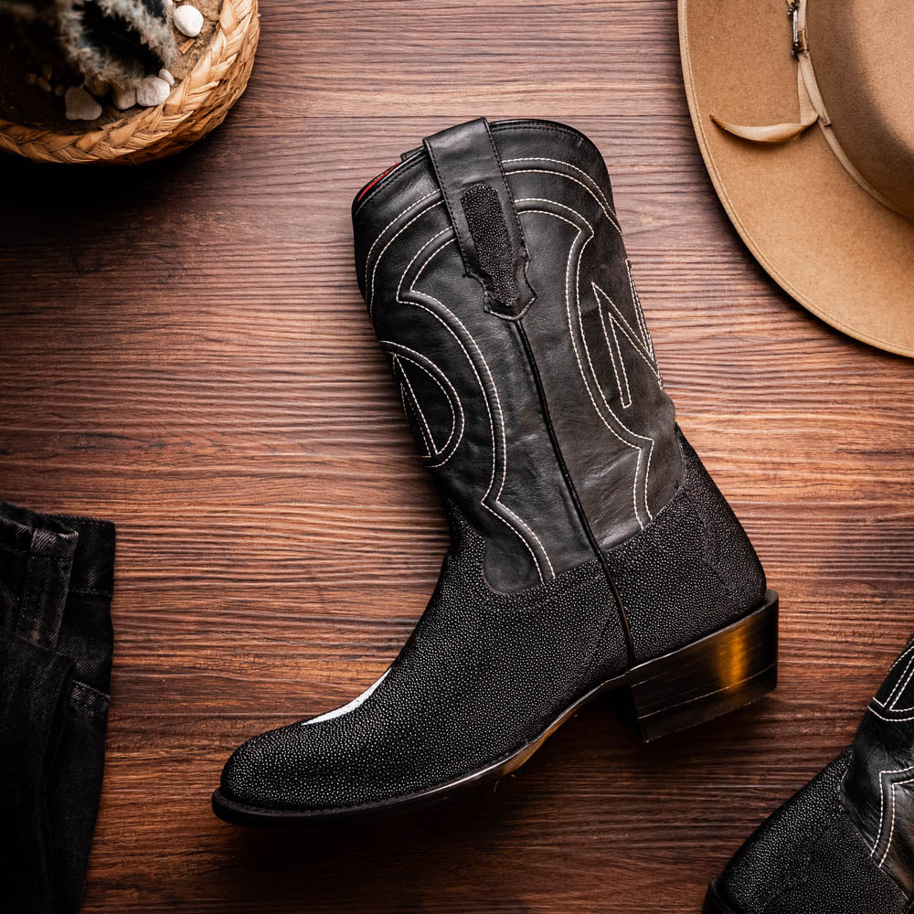 A pair of Georgia Black handcrafted western boots by Marco Di Milano, featuring white stitching—one boot upright and the other on its side displaying the branded sole.