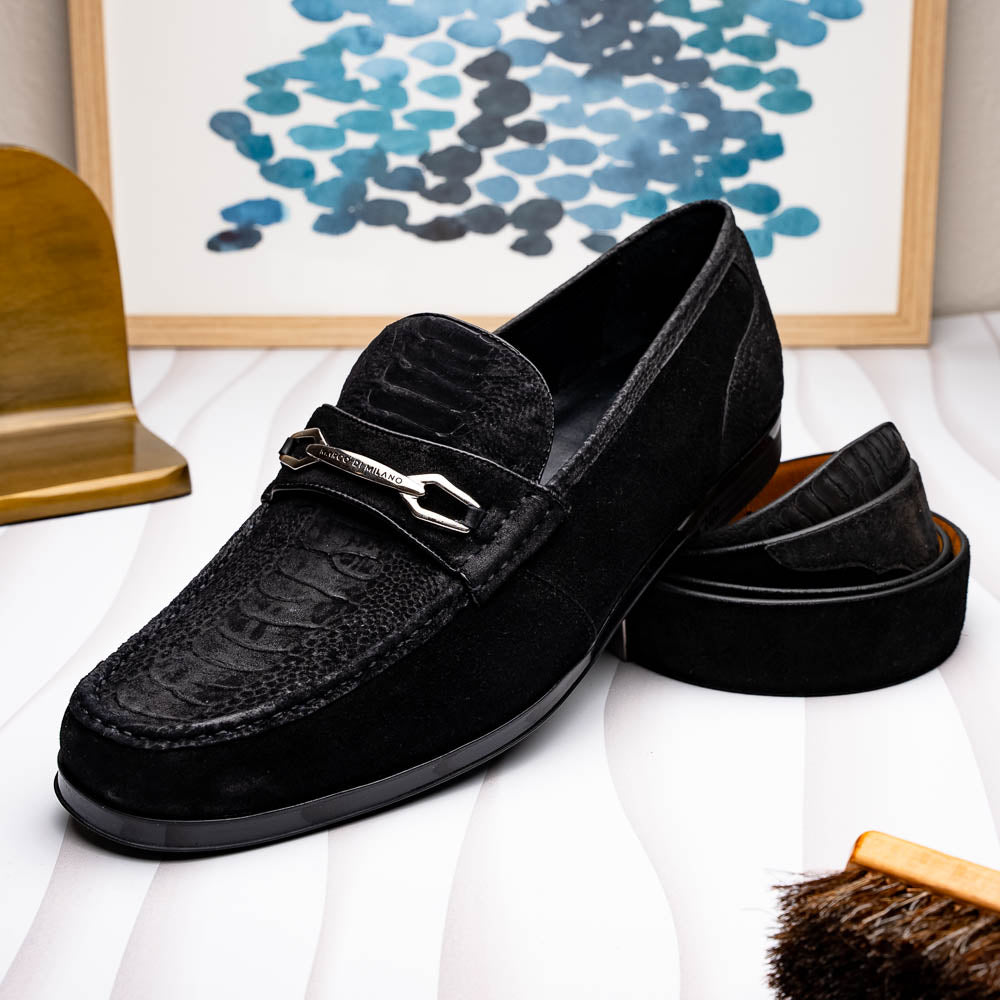 A pair of Marco Di Milano Hugo Black sueded ostrich leg loafers with metal chain detailing and textured rubber soles, one upright and one on its side, display refined luxury craftsmanship.