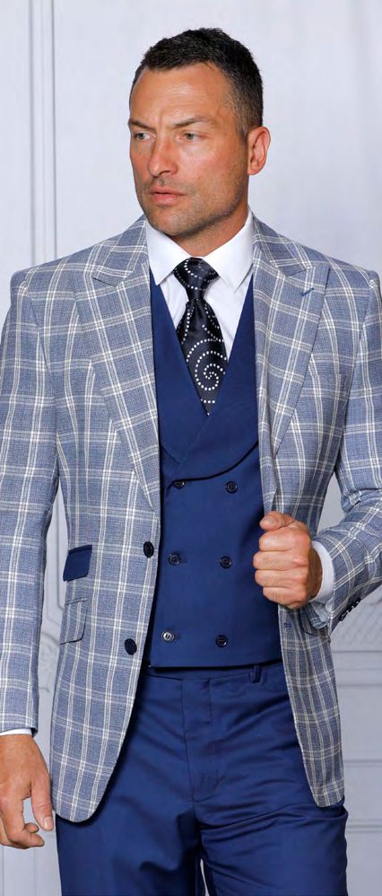 A person wearing an INSOMNIA PARIS-1 3PC Tailored fit Blue Suit by Insomnia, complemented by a waistcoat and patterned tie, stands against a neutral background.