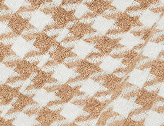 A man models the Inserch Houndstooth Suit BL264-09 Khaki by Inserch, paired with a white turtleneck, standing against a beige background and highlighting the suit's modern fit.