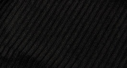 A person in a plaid jacket, sleek modern fit Inserch Cotton Flat Front Corduroy Pants P3103 in gray, and white sneakers is standing on a beige background.