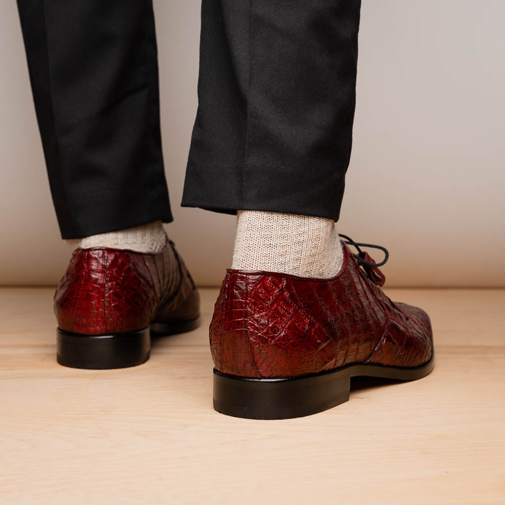 The Lacio Wine by Marco Di Milano is a luxury men's dress shoe crafted from brown genuine caiman crocodile leather, featuring a red inner lining, black laces, and "Marco Di Milano" branding on the tan leather sole.
