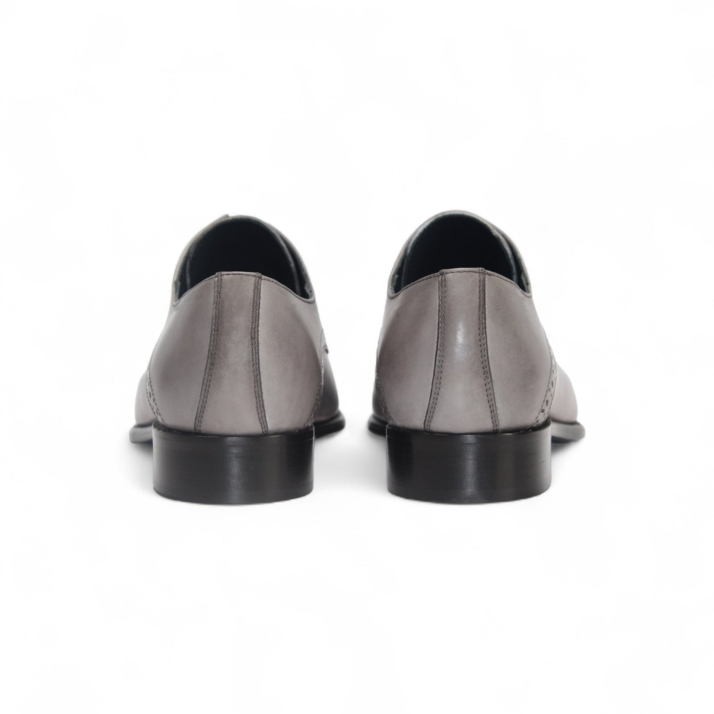 The Duca Lombardi Light Grey by Duca Di Matiste is an Italian-made genuine leather dress shoe with black laces, a low heel, and decorative perforations on the side and toe cap, shown against a white background.