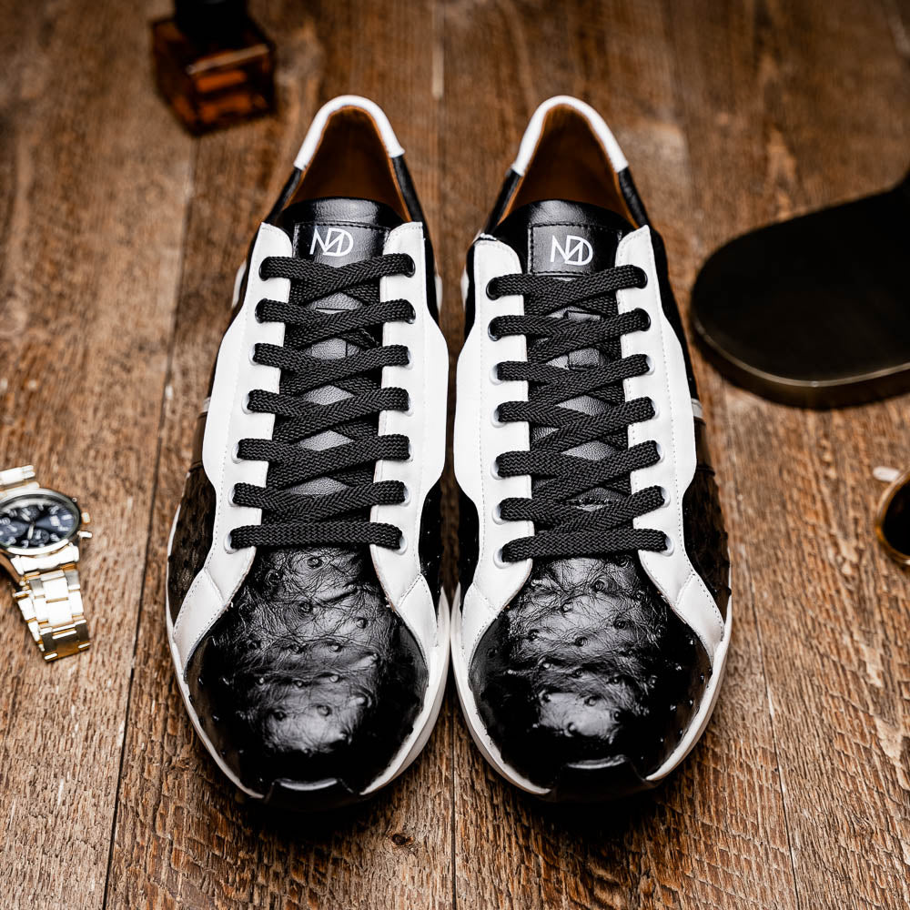 The Marco Di Milano Lyon II Black / White sneakers feature textured leather uppers, black laces, and rubber soles, displayed against a plain white background.