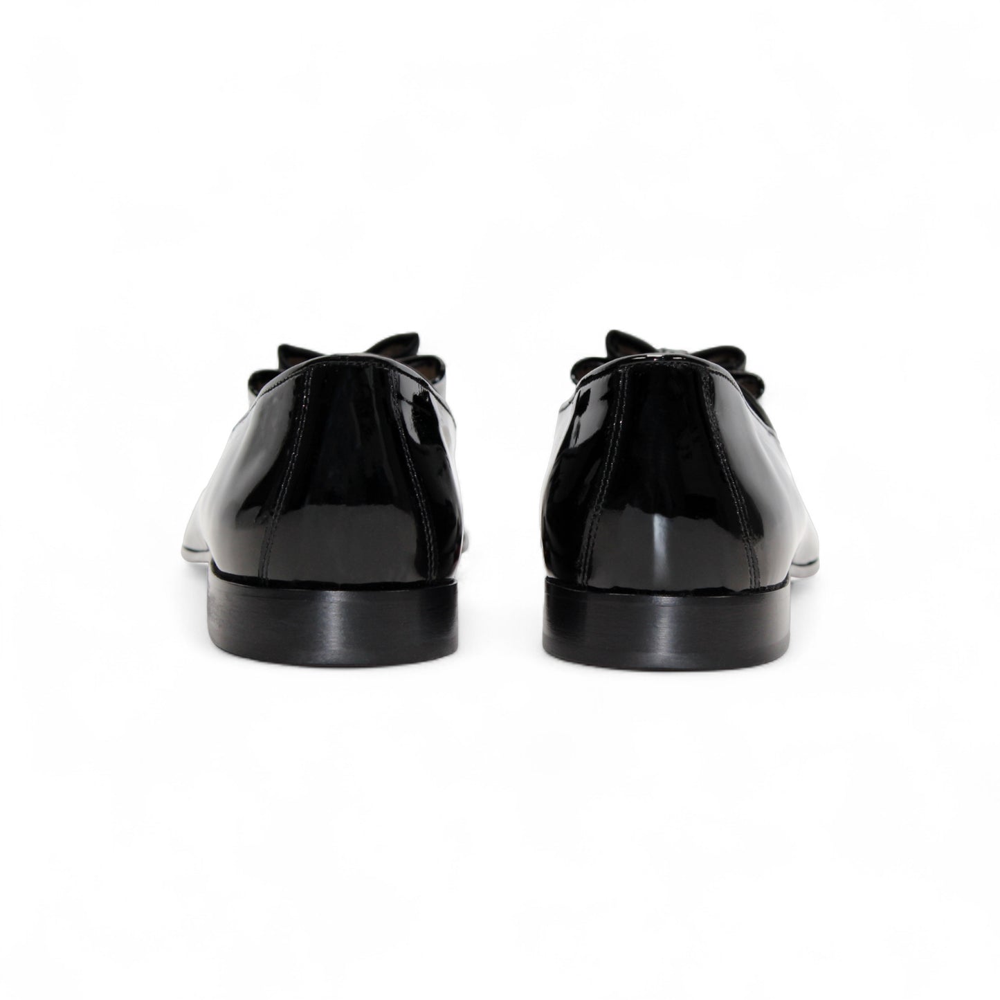 The Duca Maratea Black by Duca Di Matiste is a black patent leather loafer with a low heel, suede strap, and metal studs, highlighting fine Italian craftsmanship against a white background.