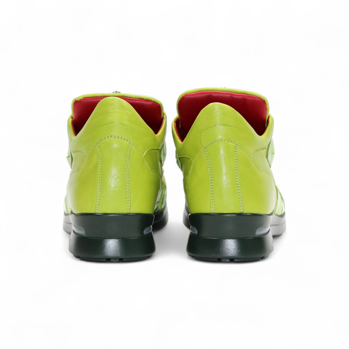 The Fennix Mason Green by Fennix of Italy is a bright green sneaker with a reptile-skin pattern, light green laces, black sole, and a distinctive oval-shaped eyelet detail on the side—an ode to classic Italian alligator shoes.