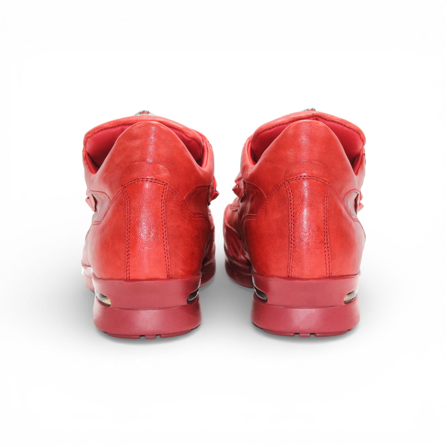 The Fennix Mason Red by Fennix of Italy is a modern red leather athletic shoe with laces and a tongue emblem, displayed in side profile on a white background.