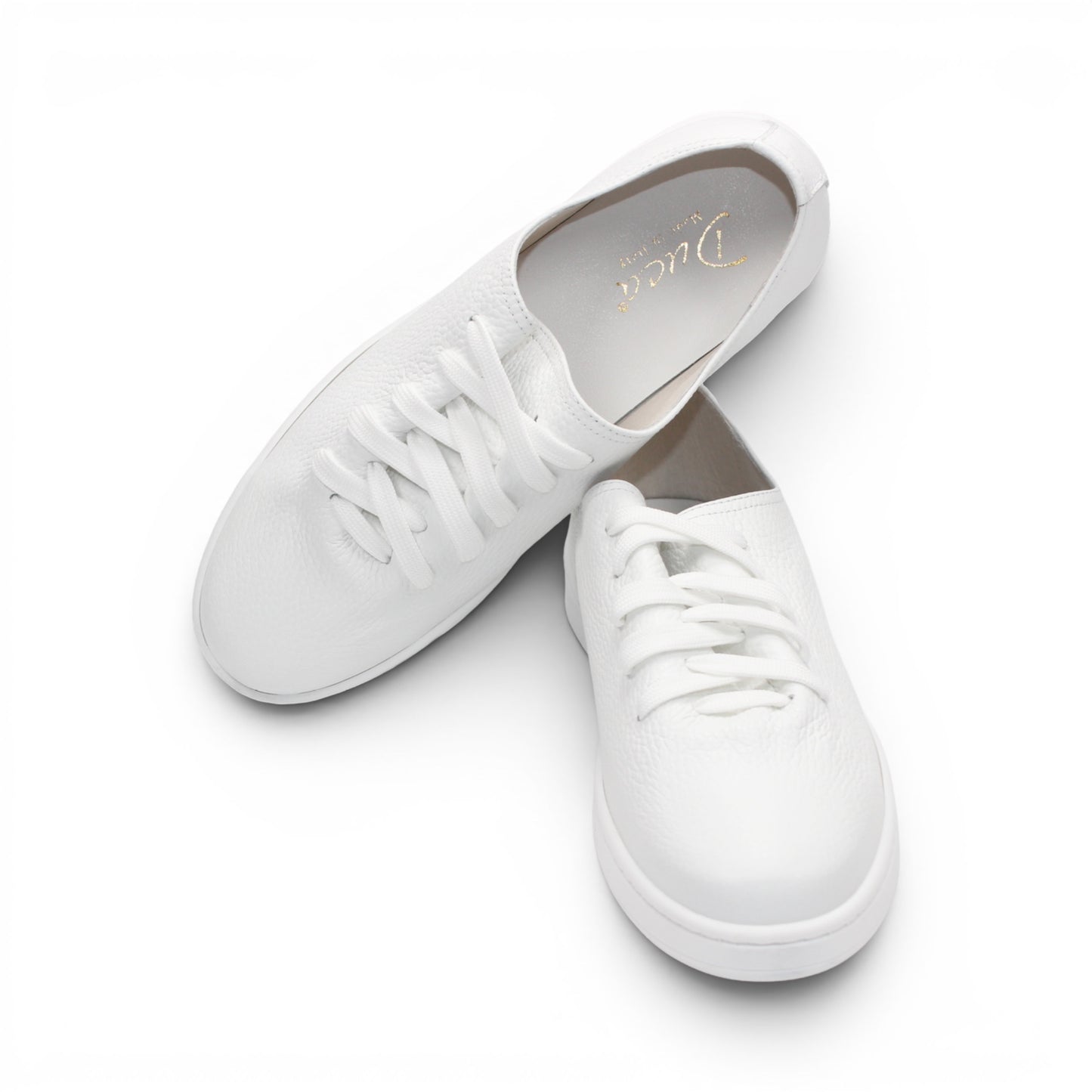 The Duca Max White by Duca Di Matiste is a low-top sneaker with white laces and a textured premium Dollaro leather upper, shown in profile against a white background—ideal for modern casual style.