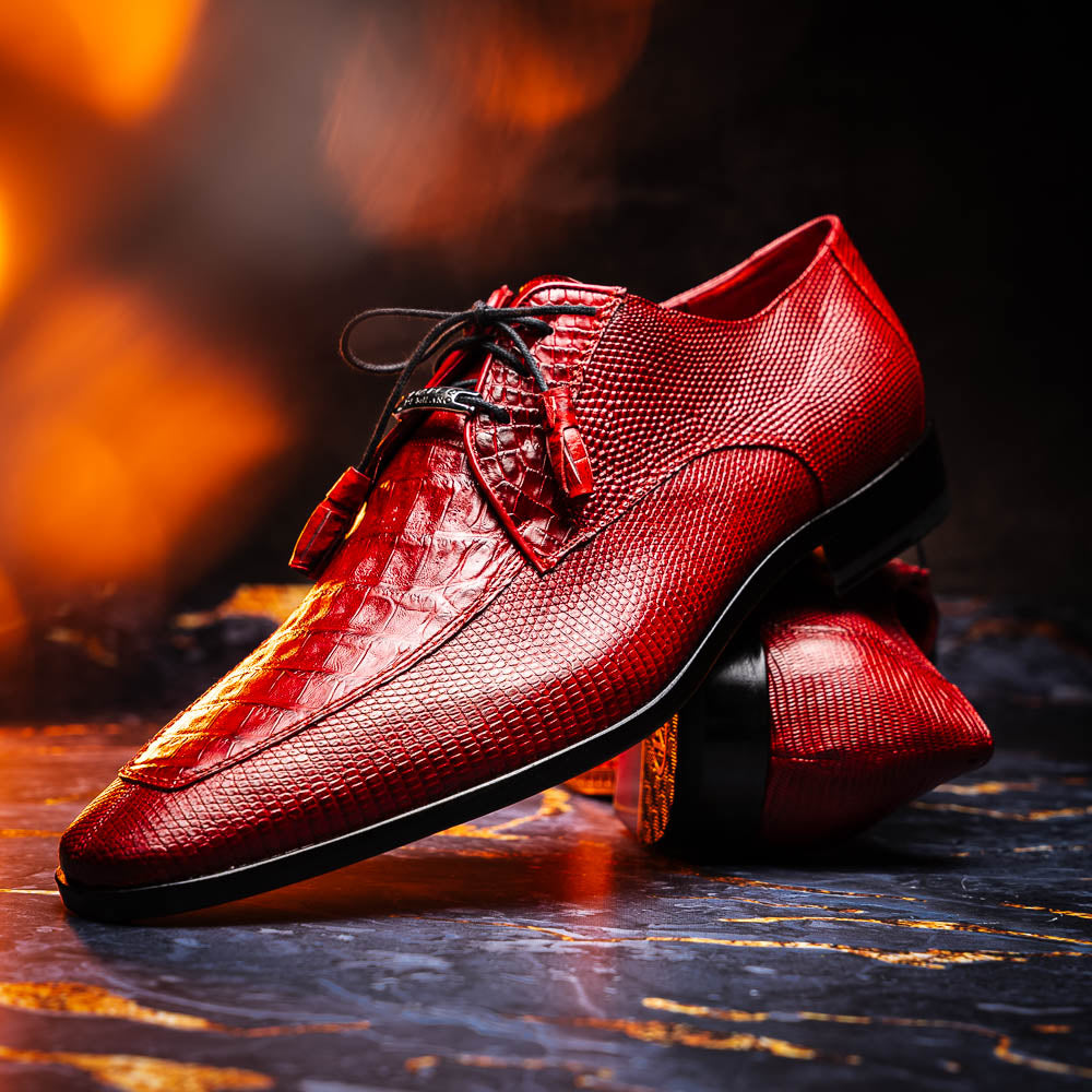 The Merida Red by Marco Di Milano are red textured leather luxury dress shoes with black laces and red tassels, shown both upright and sideways to highlight their hand-painted sole finishes.