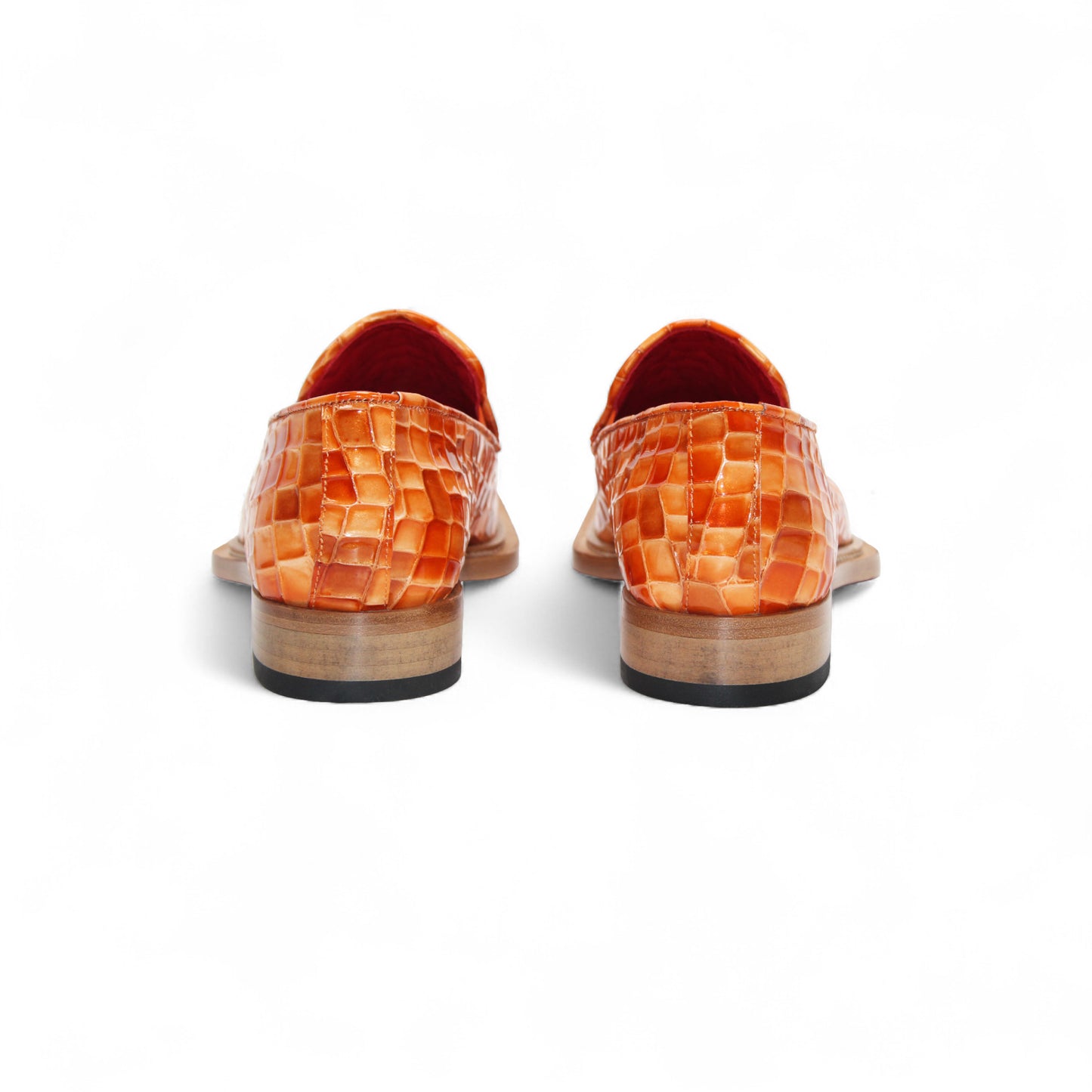 The Emilio Franco Couture Narciso Orange Combo loafer features orange woven leather, a gold buckle detail, and a low wooden heel—this bold designer shoe by Emilio Franco Couture stands out against a plain white background.