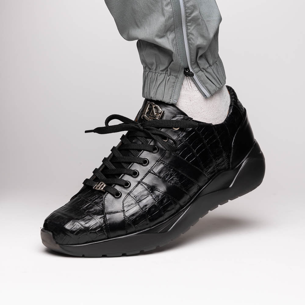 The Nino Black by Marco Di Milano: genuine black caiman crocodile sneakers with black laces and a textured rubber sole, one standing and one leaning, highlighting luxury footwear with a striking hand painted finish.