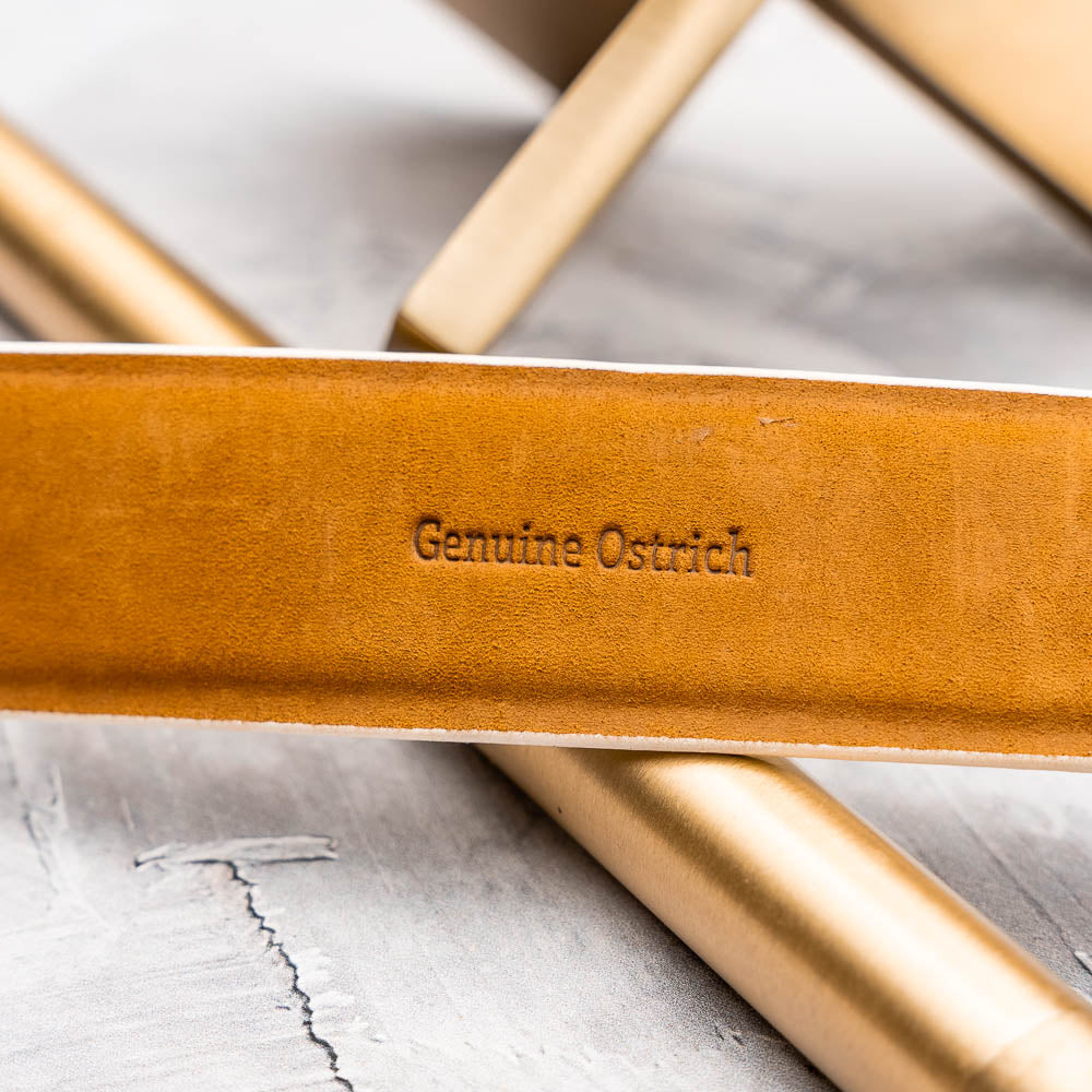 The Domenico Belt White by Marco Di Milano is a white leather belt with a silver buckle, subtle ostrich-inspired texture, and embossed Marco Di Milano branding on the strap and buckle.