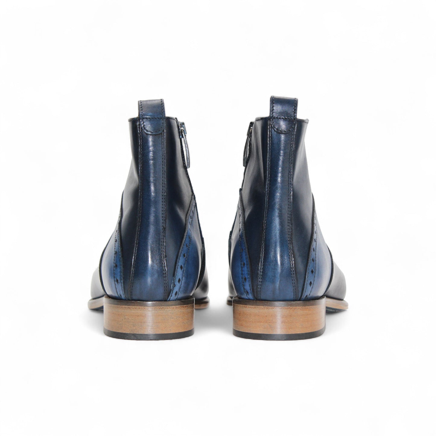 The Duca Pedaso Navy by Duca Di Matiste is a genuine leather ankle boot in blue, featuring black stitching, a side zipper, low wooden heel, and pointed toe, displayed in profile against a white background.