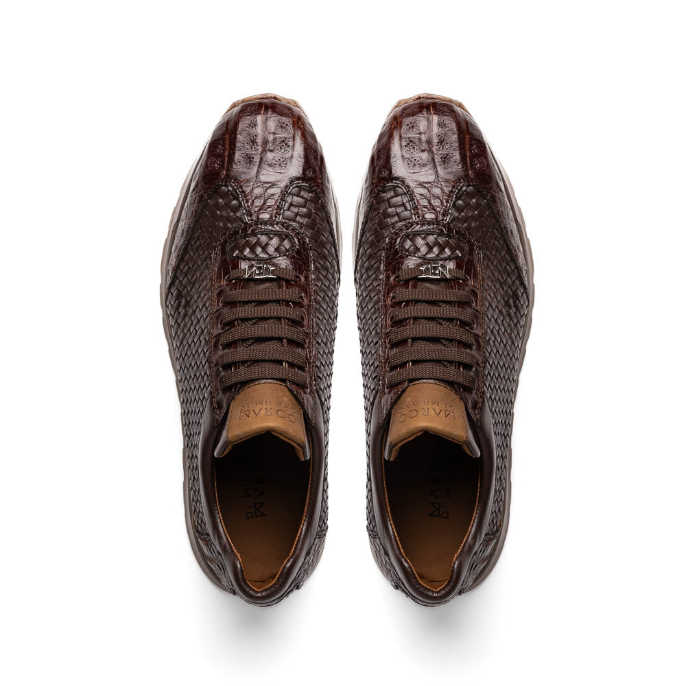 The Marco Di Milano Roma Brown sneakers feature hand-painted textured leather, woven detailing, and rubber soles. One luxury pair stands upright while the other is tilted beneath it.